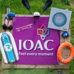 Outdoor gear displayed on IOAC sign with a life ring and paddle.